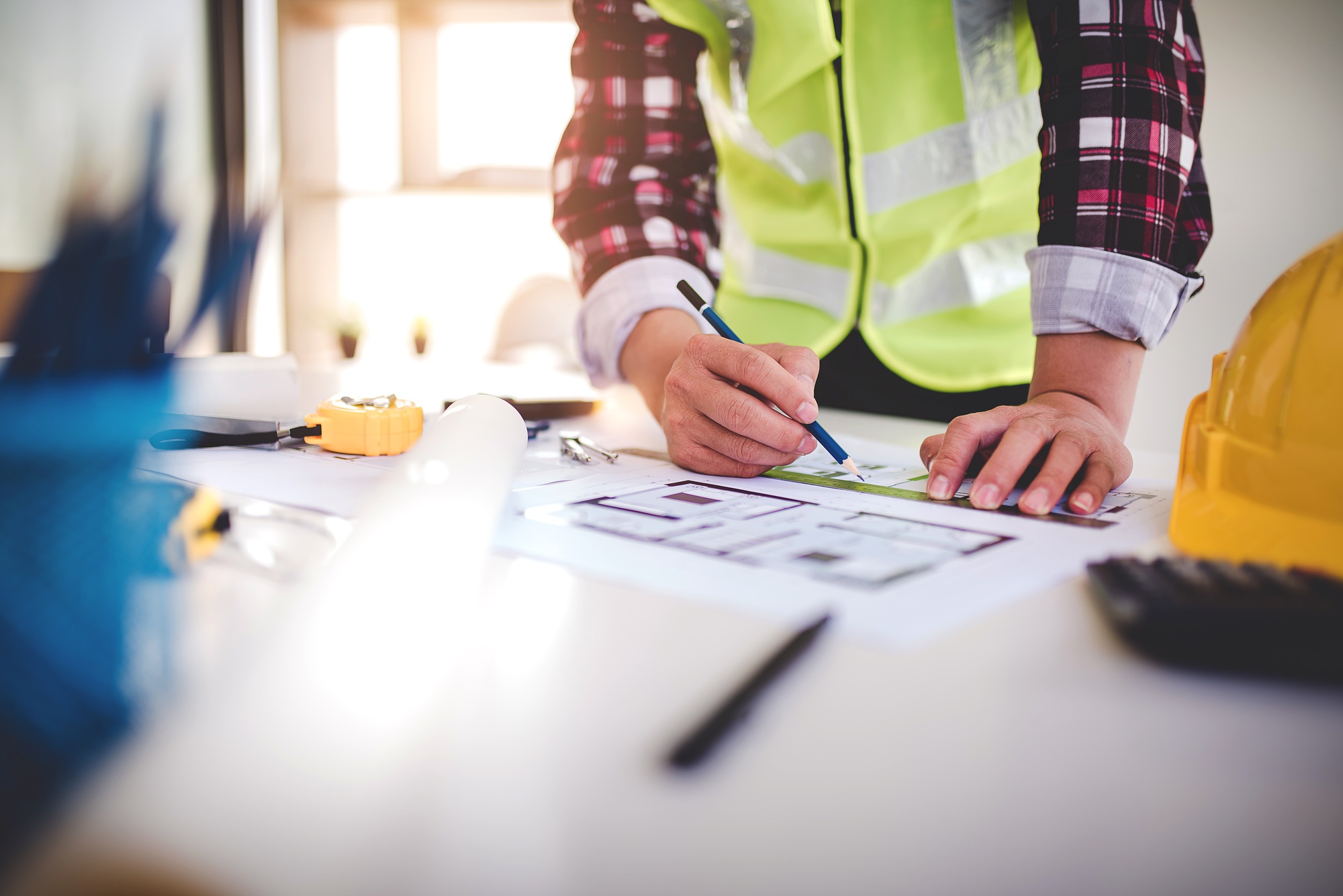 architect concept, working architect with blueprints in office to present to customers